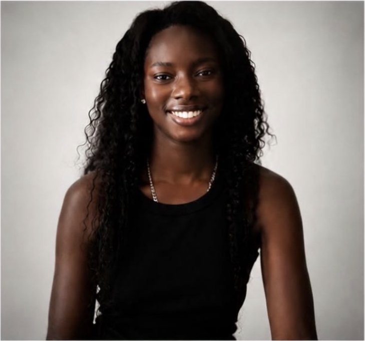 Stephanie O, female model, smiling studio portrait in a black vest