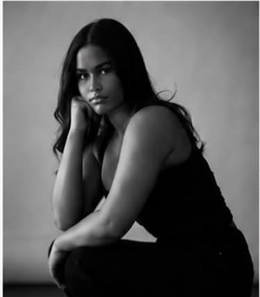 Ava Mc seated black and white editorial portrait