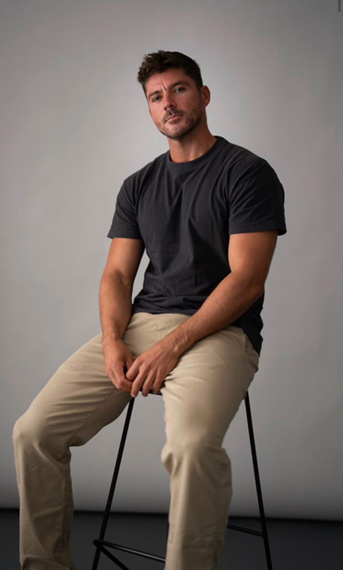 Commercial studio portrait seated on stool