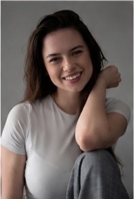 Katrin T smiling portrait in a white t-shirt