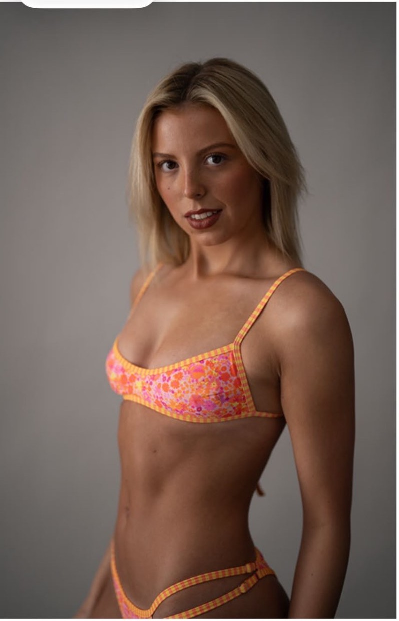 Swimwear studio portrait against a grey backdrop