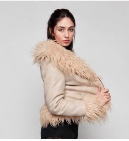 Lila B in a textured cream jacket, studio fashion portrait