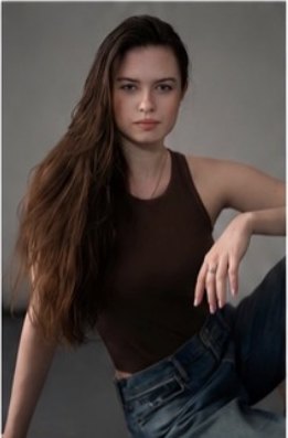 Katrin T seated portrait with long hair swept to one side